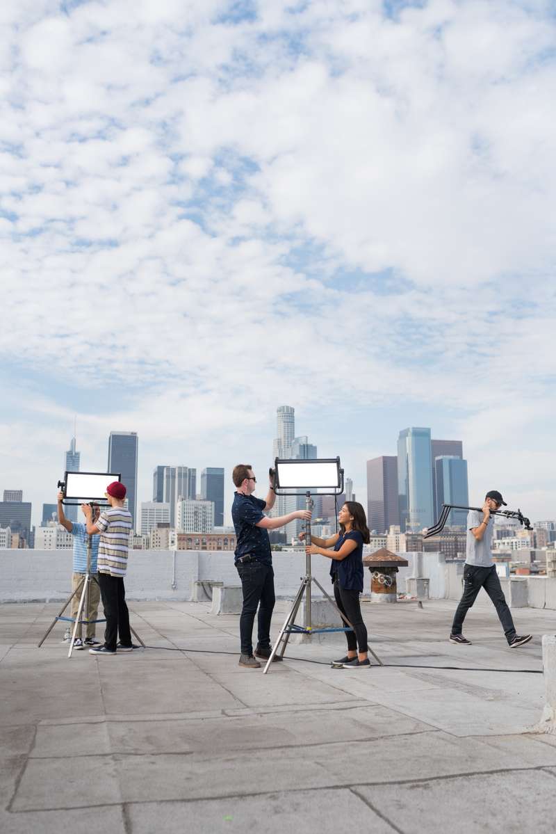 Students set up lights on a Downtown Los Angeles rooftop