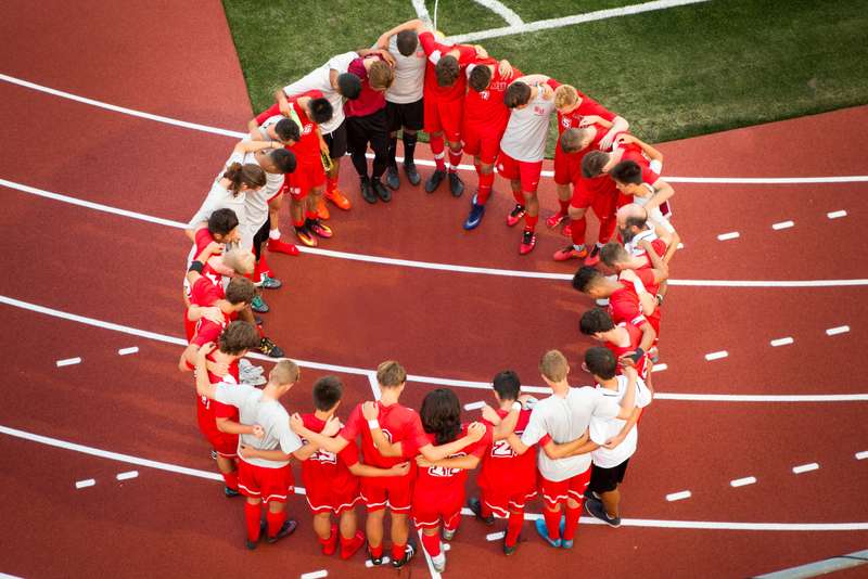 Soccer players huddled together