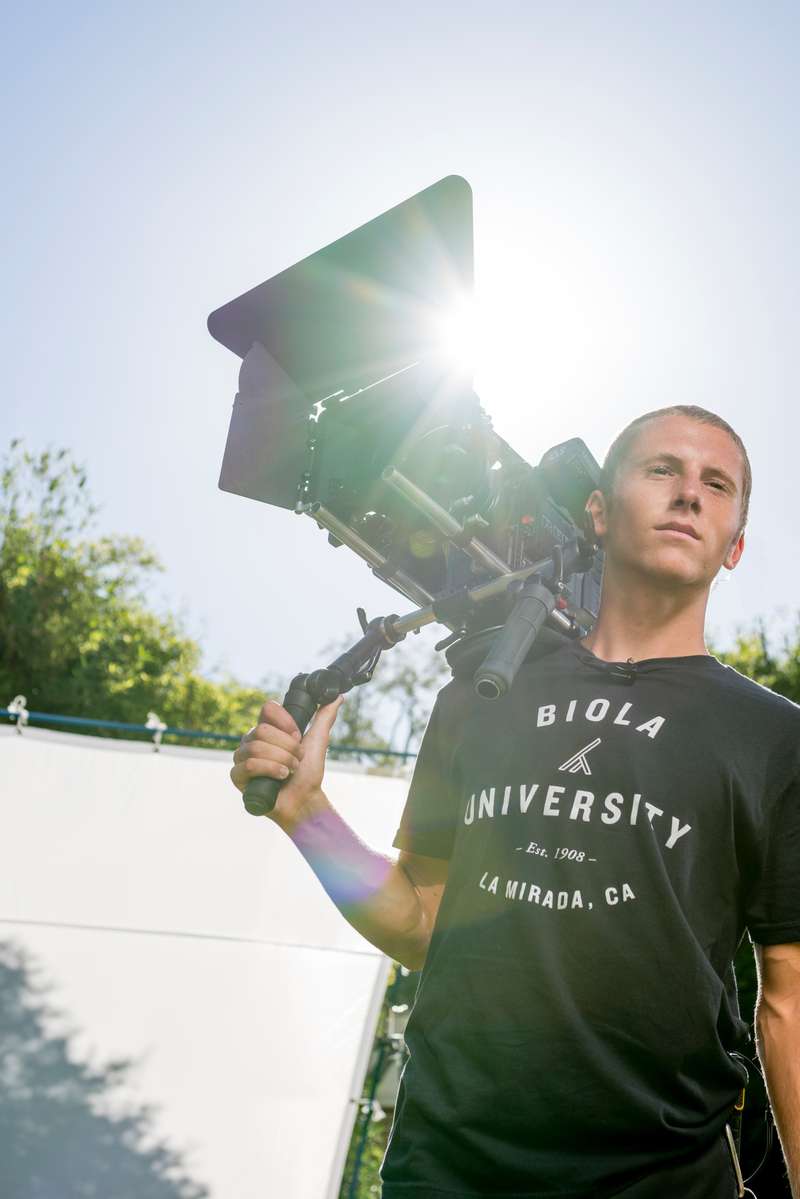 Student holds a cinema camera rig