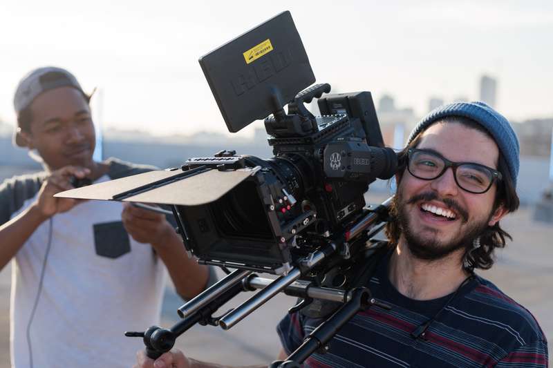 Student holds a cinema camera rig