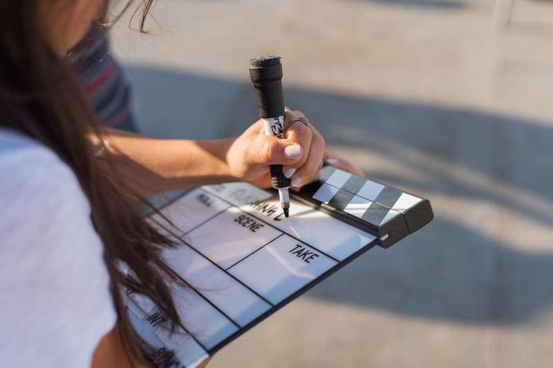 Student writes on a slate